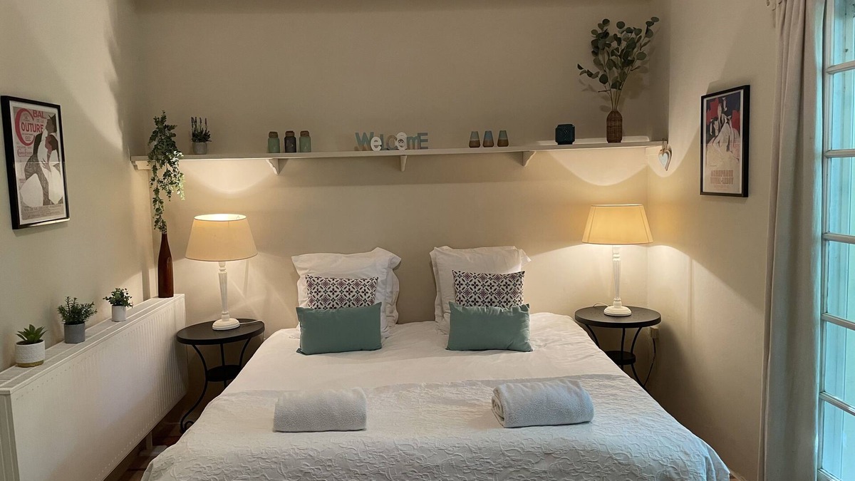 Villamblard Bed & Breakfast | A beautiful romantic bedroom with a mezzanine area, bathroom and private garden