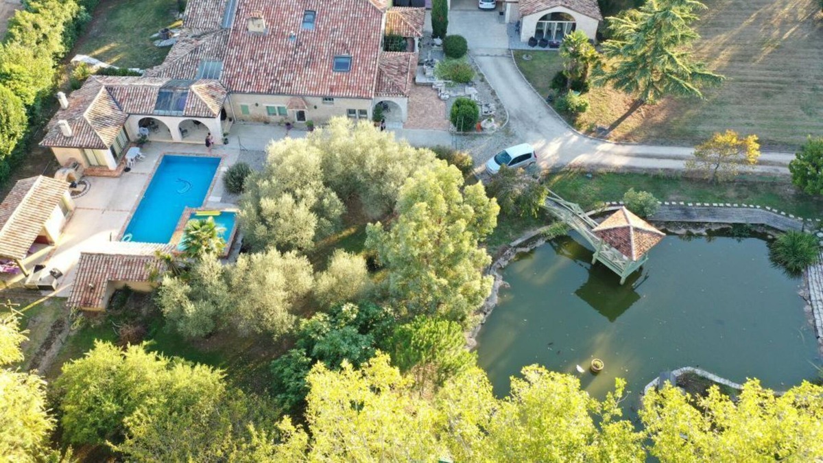 Montpouillan House | A bucolic stone estate with a cascading pool.