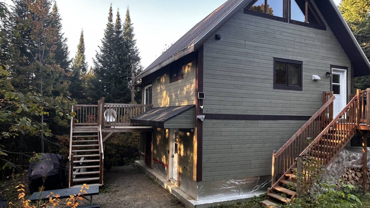Notre-Dame-Des-Bois Cabin | A cozy rustic mountain side cabin with a small river on the property.