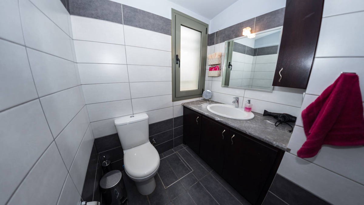 Porto Heli Cottage | A detached house which is embraced by green trees and beautiful flowers.