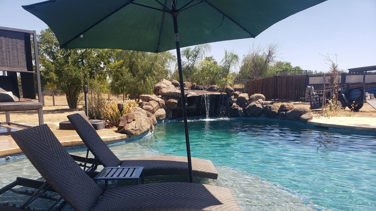 Woodland House | Althea House features a pool, firepit, grilling station, and friendly goats!
