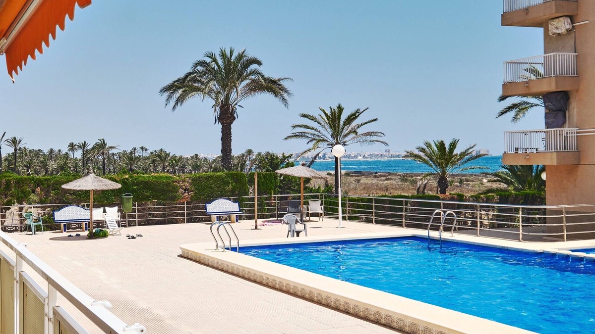 Punta Prima Apartment | Apartment with 2 bedrooms, Wi-Fi, air conditioning, sea view, pool, and garage
