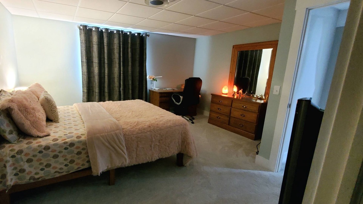 Williston North Condo | Basement Space with bedroom, living room, movie theatre and gym.