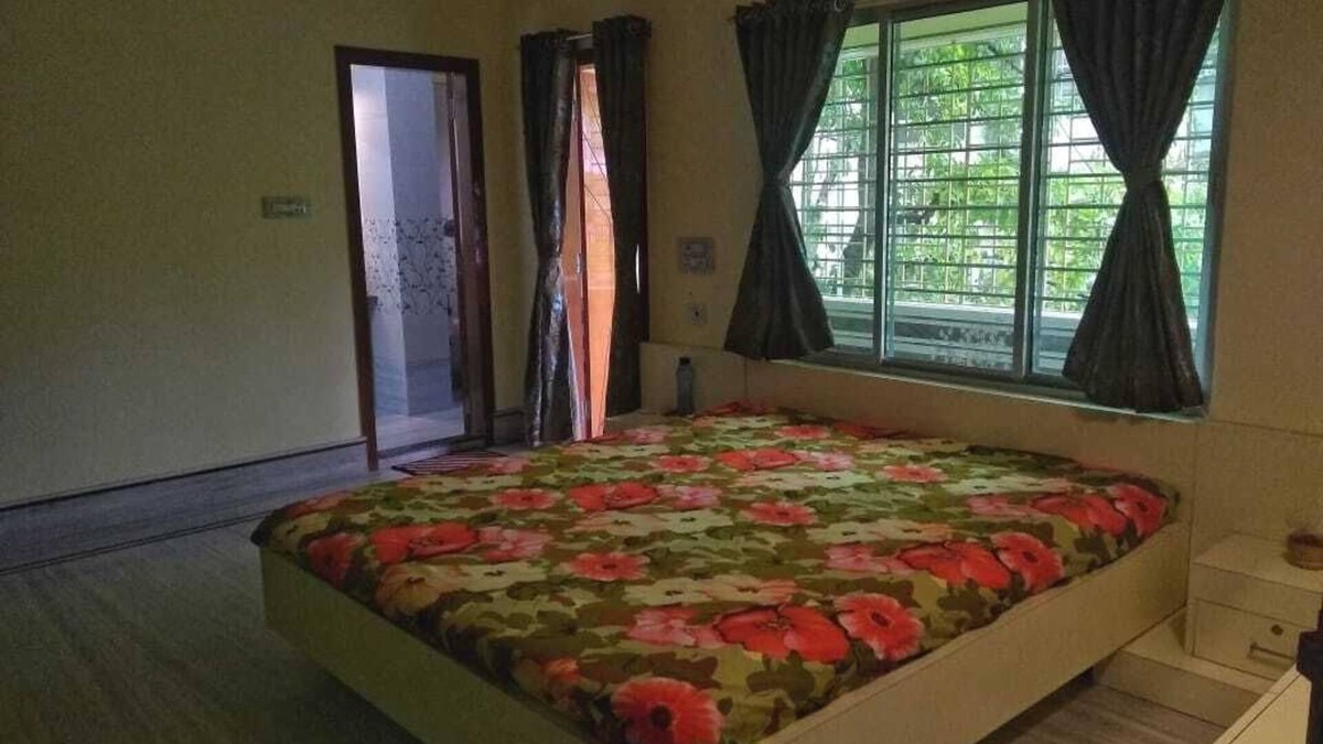 Siliguri Apartment | Bashundhara- A beautiful, spacious room with a bath and balcony.
