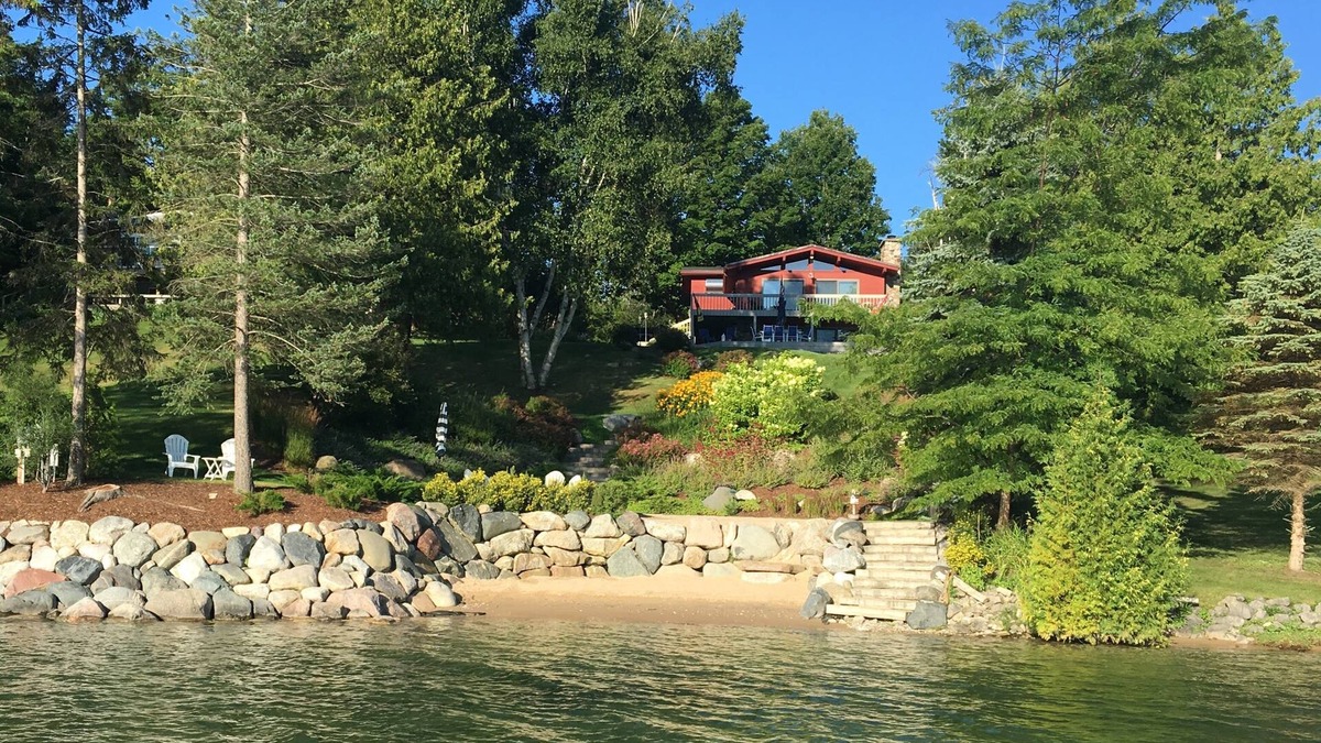 East Jordan House | Beautiful sloping view to water's edge on this Lake Charlevoix South Arm escape.