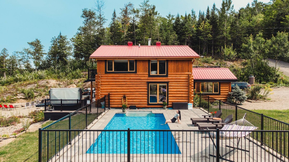 Mandeville Cabin | Charming log cabin nestled in the woods, with a spa and in-ground pool.
