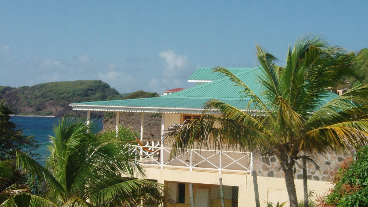 Friendship House | Charming seaside villa with wraparound veranda, ocean views and wind.