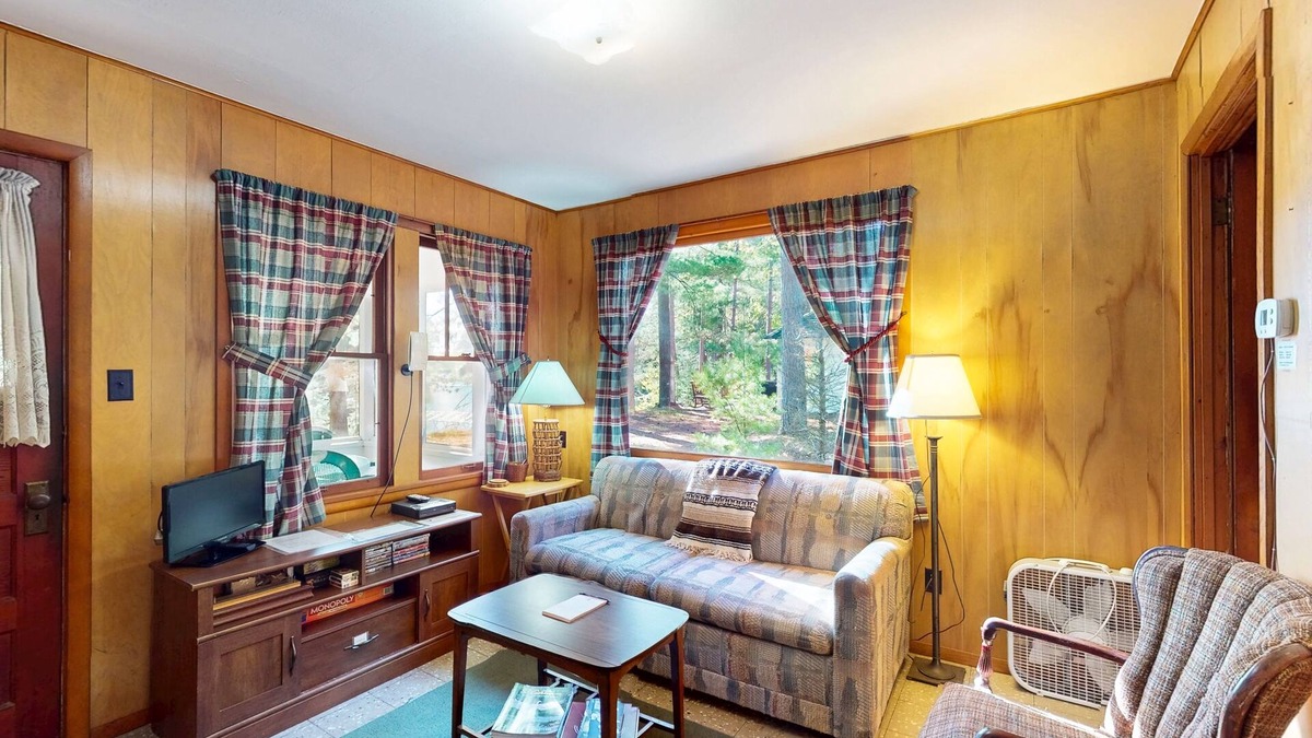 Manitowish Waters Cabin | Charming waterfront cottage with shared firepit, canoe, paddlebaot & docks