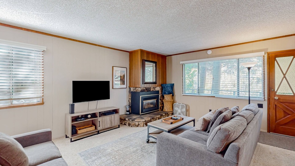 Tahoe Island Cabin | Classic central cabin near river with large tree-lined deck, grassy yard & gym