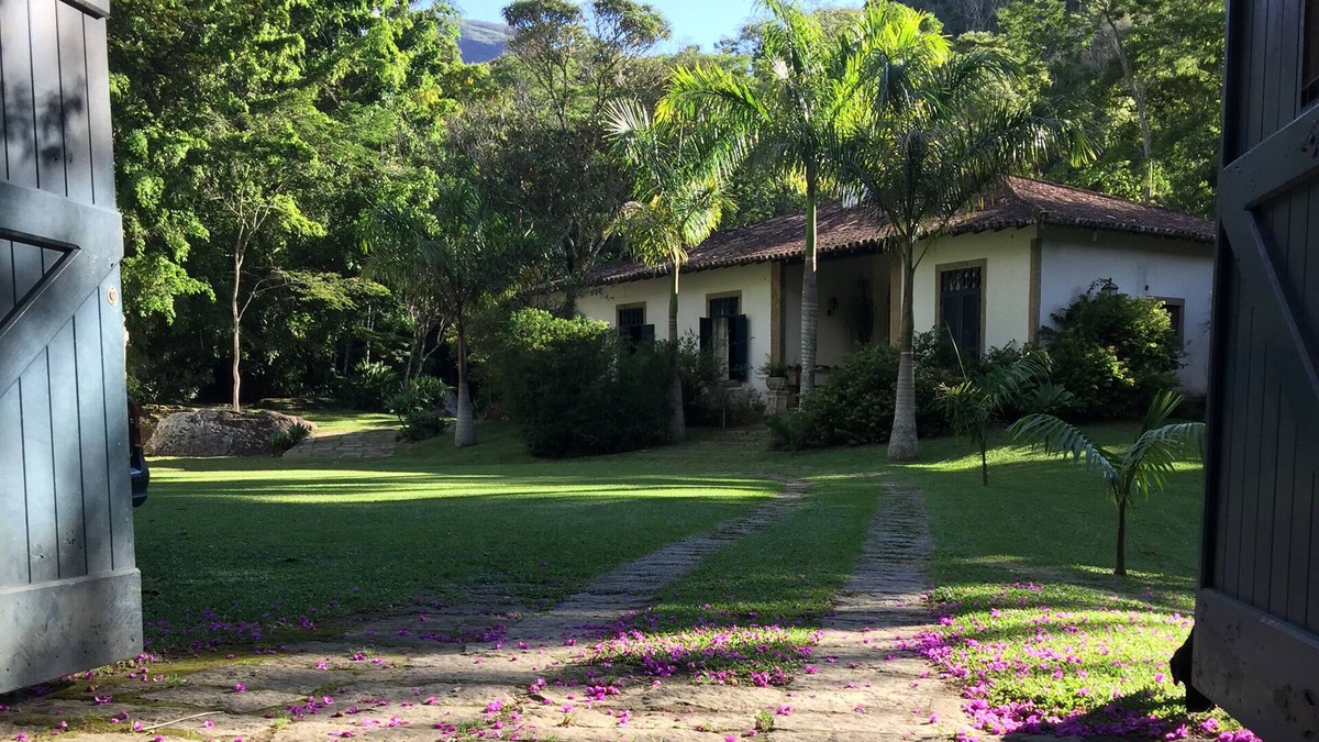 Correas House | Colonial house with a smaller house on the edge of a river and along the forest.