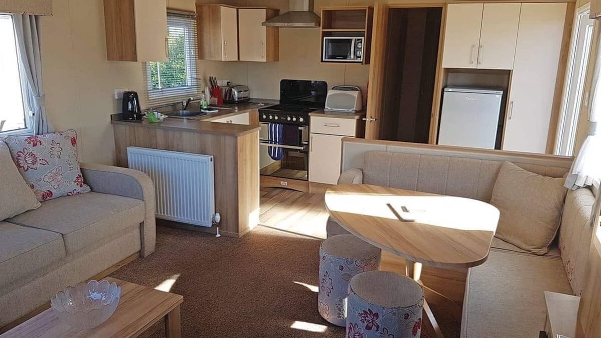 Kilcreggan House | Contemporary 12ft-wide caravan with one double and two twin.