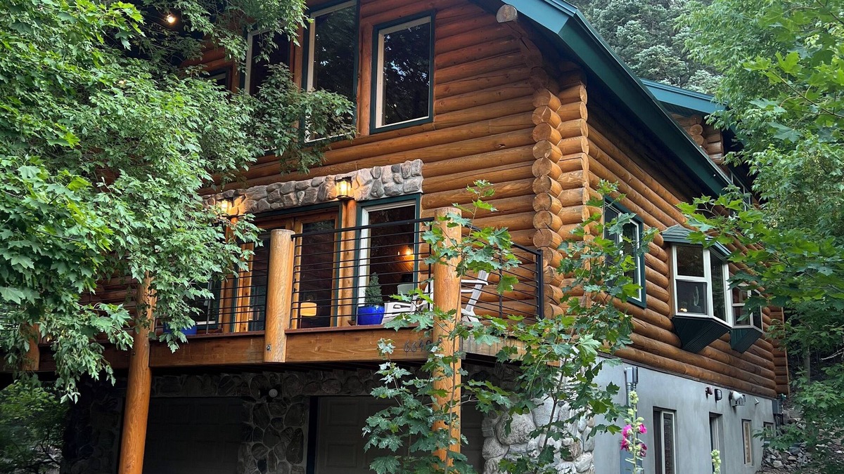 Snowbird Cabin | Cozy log cabin secluded in a mountain forest with hot tub, sauna, private patio.