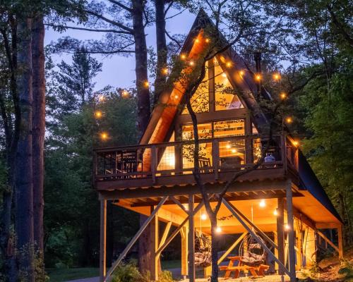 Johnson House | Designer A-Frame Treehouse with hot tub on river