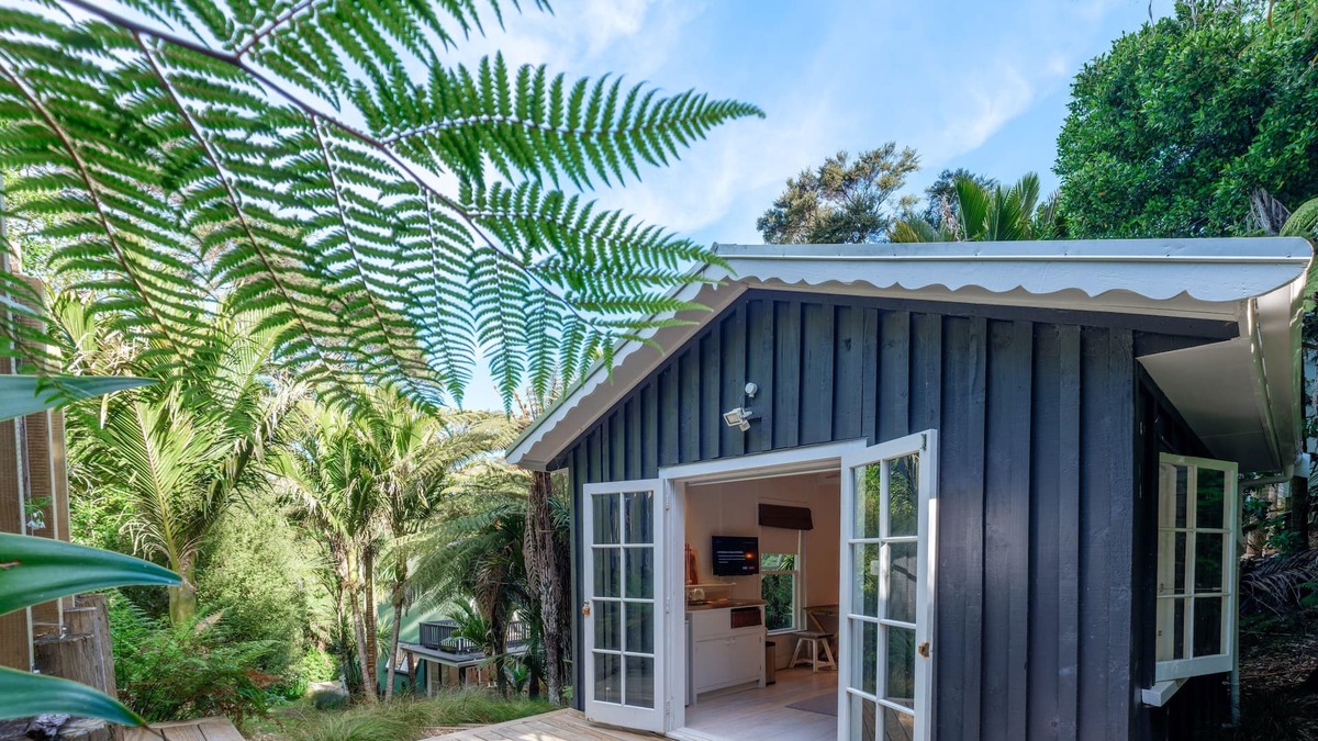 Ostend Cottage | Enchanted Valley - Enchanted Valley is a gorgeous cottage plus cabana in the heart of Waiheke Island. Located in a peaceful valley section, the sound of the birds is your constant companion. With two bedrooms and four beds, this is perfect for up to