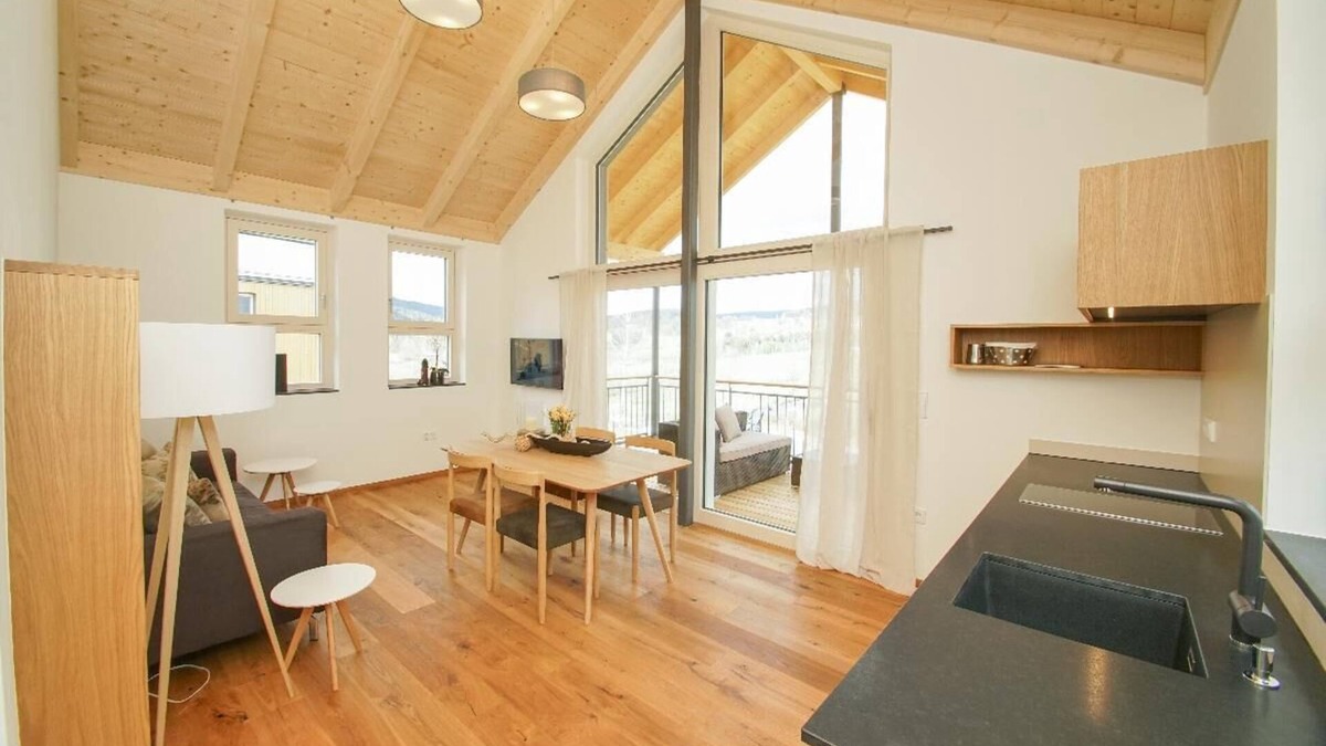 Bohmzwiesel Apartment | Ferienchalet mit überdachter Veranda mit Lounge Möbel und Schwebeliege.