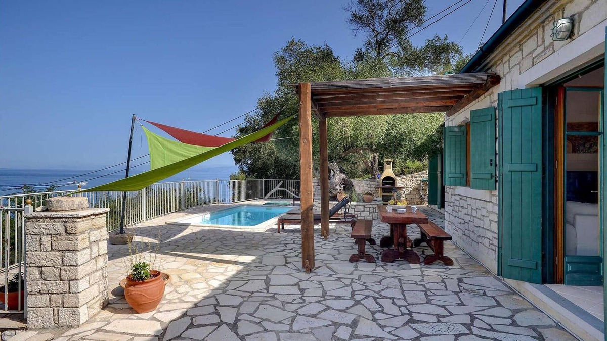 Longos House | From its elevated position directly above Levrecchio beach, this wonderfully light and airy villa en
