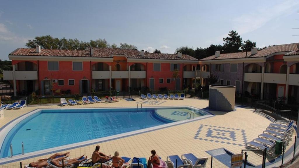 Bibione Lido del Sole Apartment | Holiday village escape with garden and fireplace