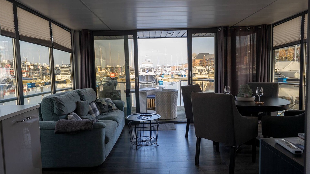 Flensburg Boat Rental | Houseboat Luv in Sonwik harbor with a view of Denmark