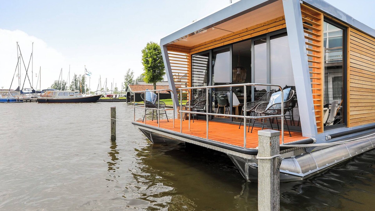 Grou Boat Rental | Houseboat Skoft with beautiful view over the water and on village Grou.