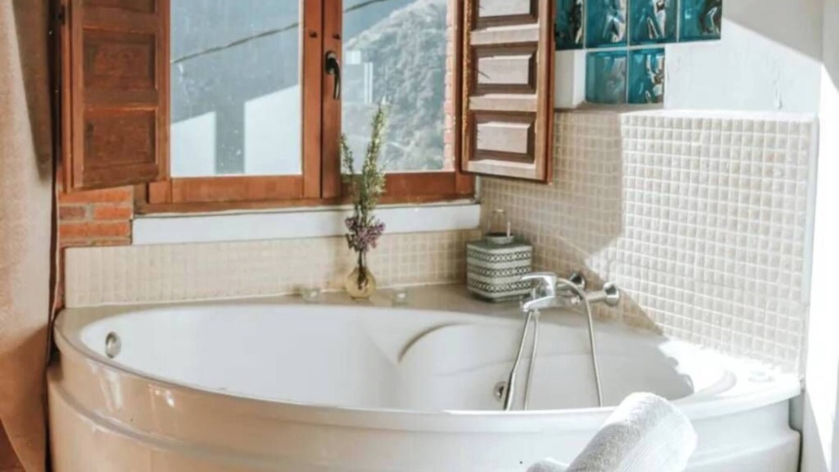 Santa Maria Apartment | Jacuzzi in bedroom with mountain views and fireplace