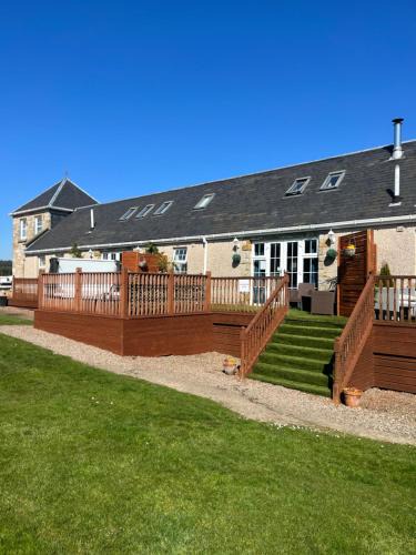 Kelty Apartment | JOIVY Greenknowes Lodge with Hot Tub and Wood Burning Stove