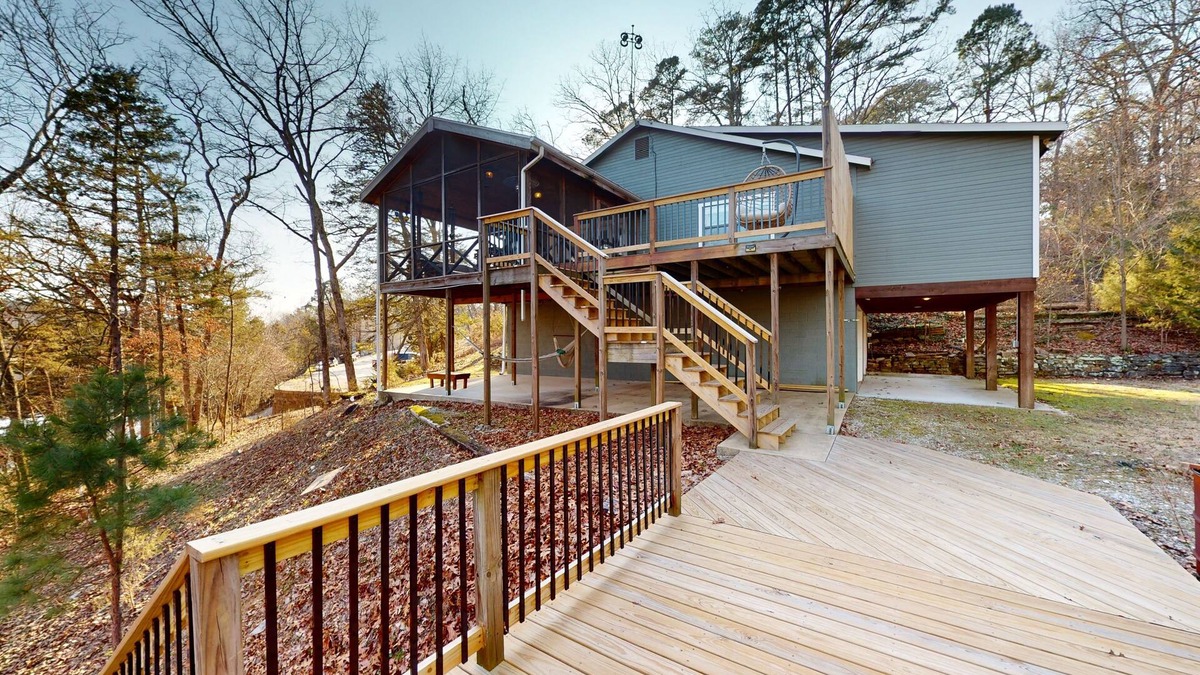 Powell House | Lakefront retreat with screened sunroom, wood stove, multiple decks, & AC