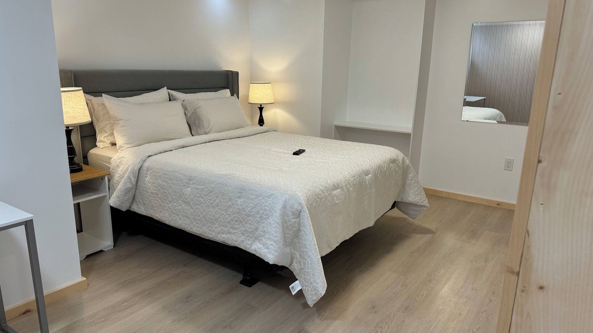 Ottawa Division House | Large bedroom with private bathroom and workspace.