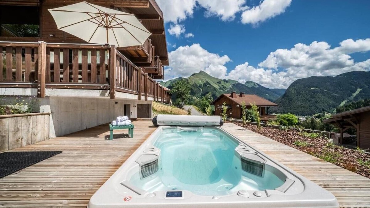La Cote-d'Arbroz Ski Chalet | Lovely wooden balconies, a swing chair with the most picturesque view