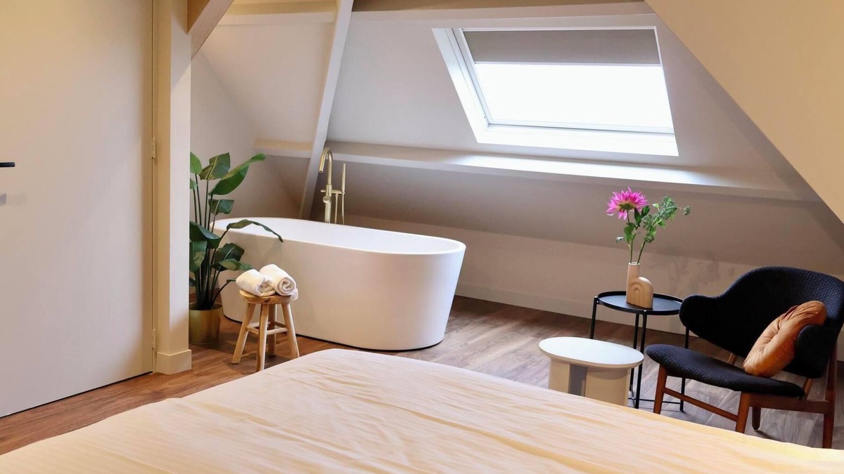 Appeltern Hotel | Luxurious family suite with river meadow views, a bathtub, and modern amenities for a relaxing family getaway.