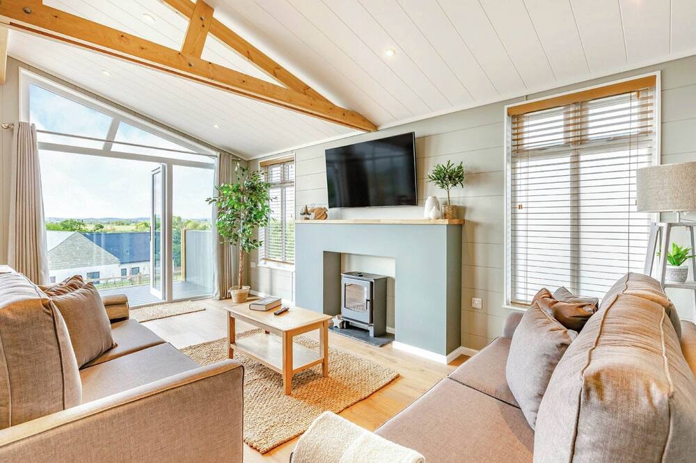 Middlezoy Ski Chalet | Luxurious lodge with vaulted ceilings and a welcoming feature fireplace.