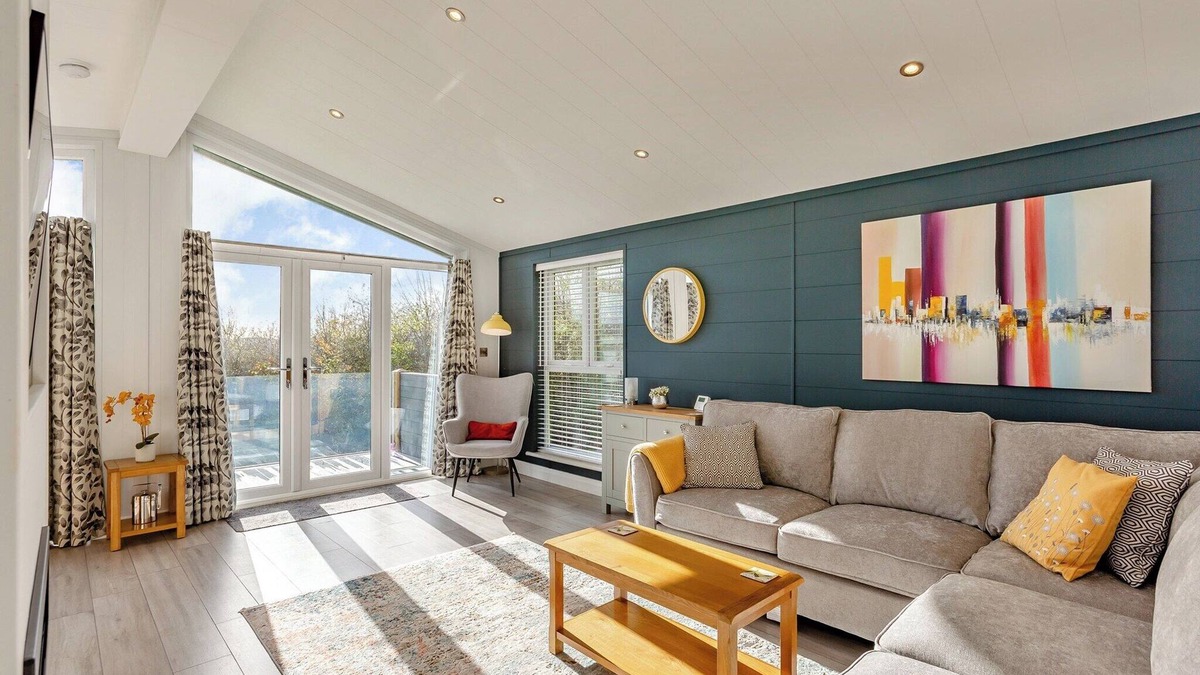 Middlezoy Ski Chalet | Luxurious lodge with vaulted ceilings and a welcoming feature fireplace.