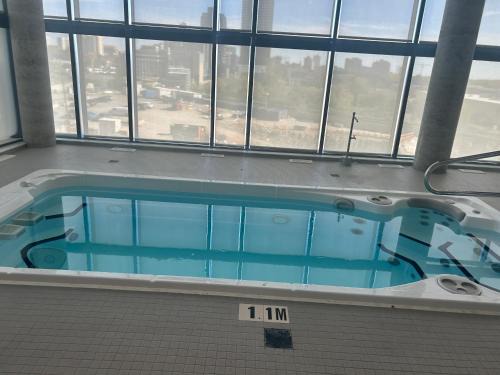 Kitchener Apartment | Luxury Condo with Hottub, outdoor firepit & Bowlin