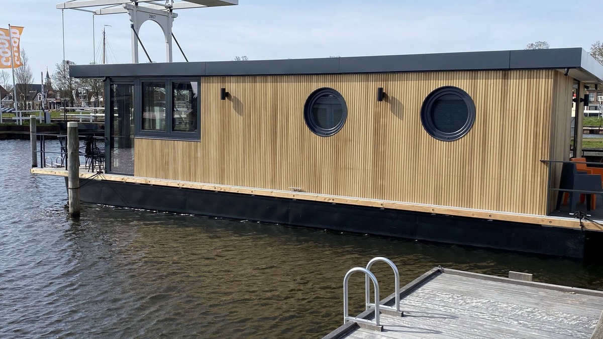 Stavoren Boat Rental | Luxury Houseboat with swim platform in colorful harbor