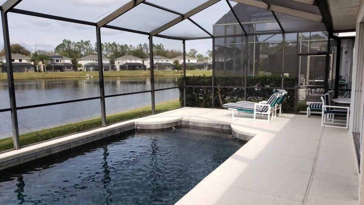 Sunset Lakes Villa | Luxury villa Near Disney Gated Lake View Heated Pool w/sunset & home office