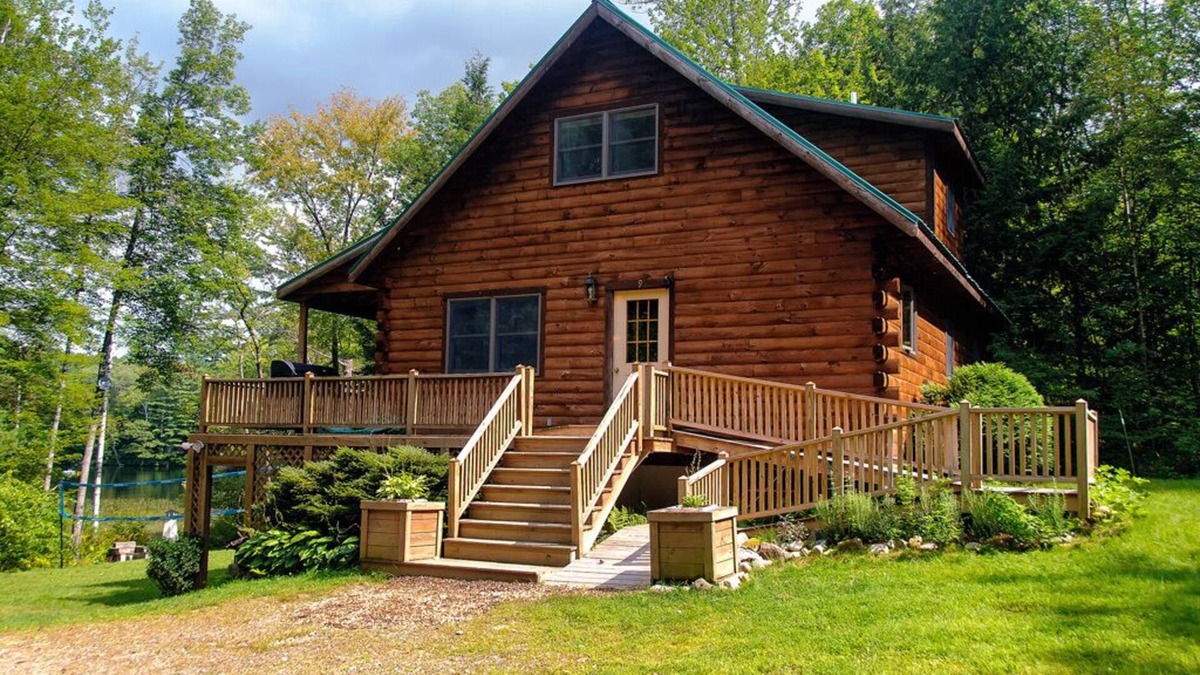 Dryden Cabin | Maine Lakeside log cabin: 3bed 2bath: hot tub-boats-swim raft-firepit- privacy!