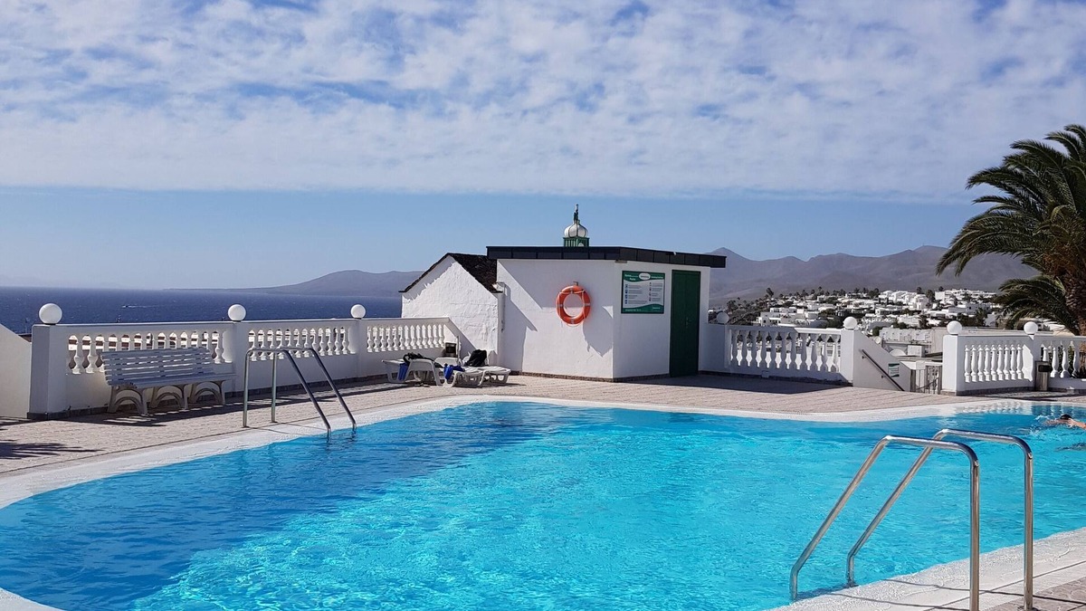 Puerto del Carmen Apartment | Modern apartment ,stunning sea and mountain views in the old town. WiFi and pool