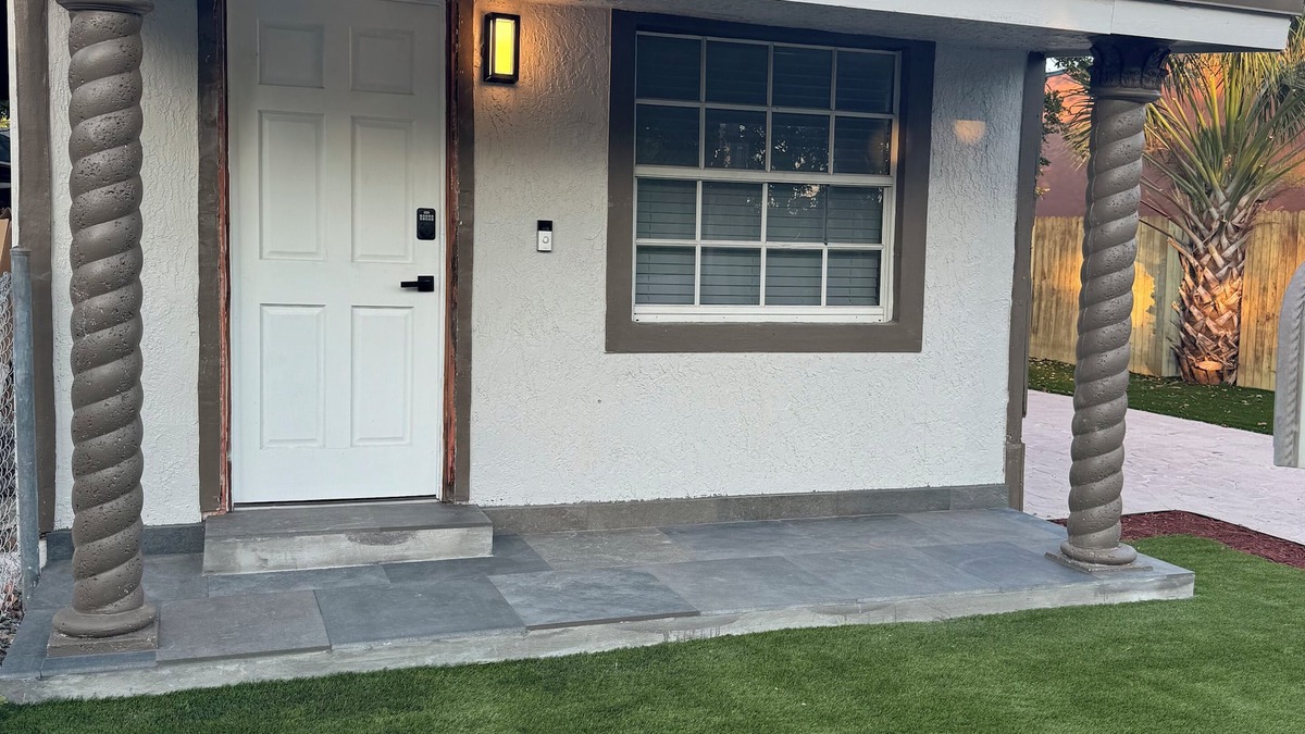 Liberty City House | Modern home with driveway parking and fenced yard.