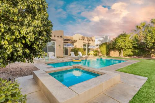 Bermuda Dunes House | Pool Hot Tub Yard Games Chic Midcentury Design Painted Sand by AvantStay