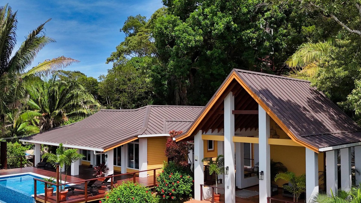 Gibson Bight House | Relax at this hillside retreat that overlooks the lush forest and the Caribbean.