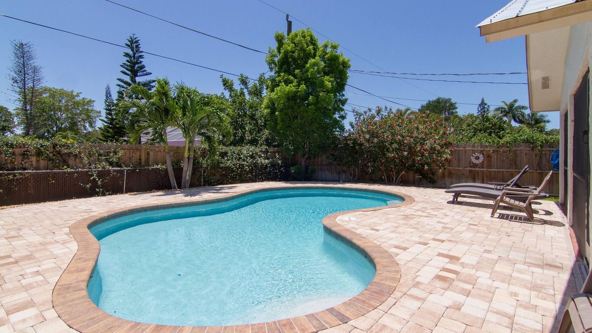 Naples Park House | Relax by the sand at nearby Vanderbilt Beach or hang by heated pool