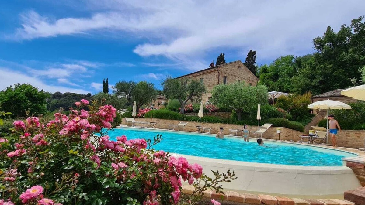 Potenza Picena Villa | Resort surrounded by greenery arranged for families or groups with an infinity pool.