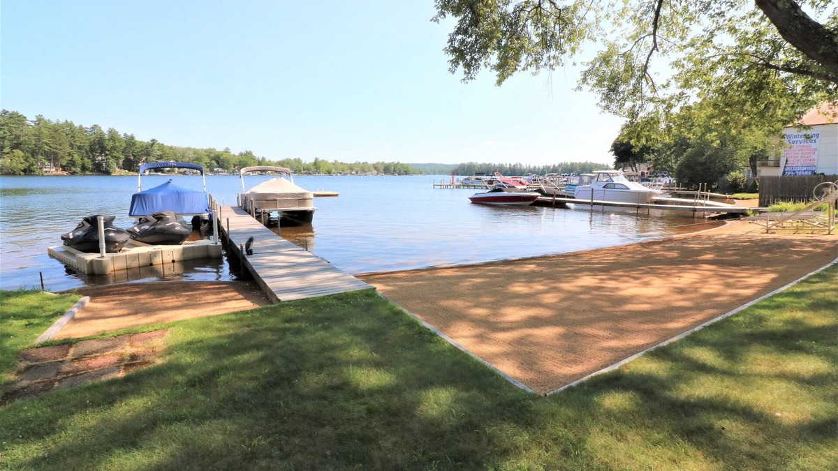 Lochmere Condo | Right on the Water at Lake Winnisquam, w/Balcony, Boat Dock, & Sandy Beach