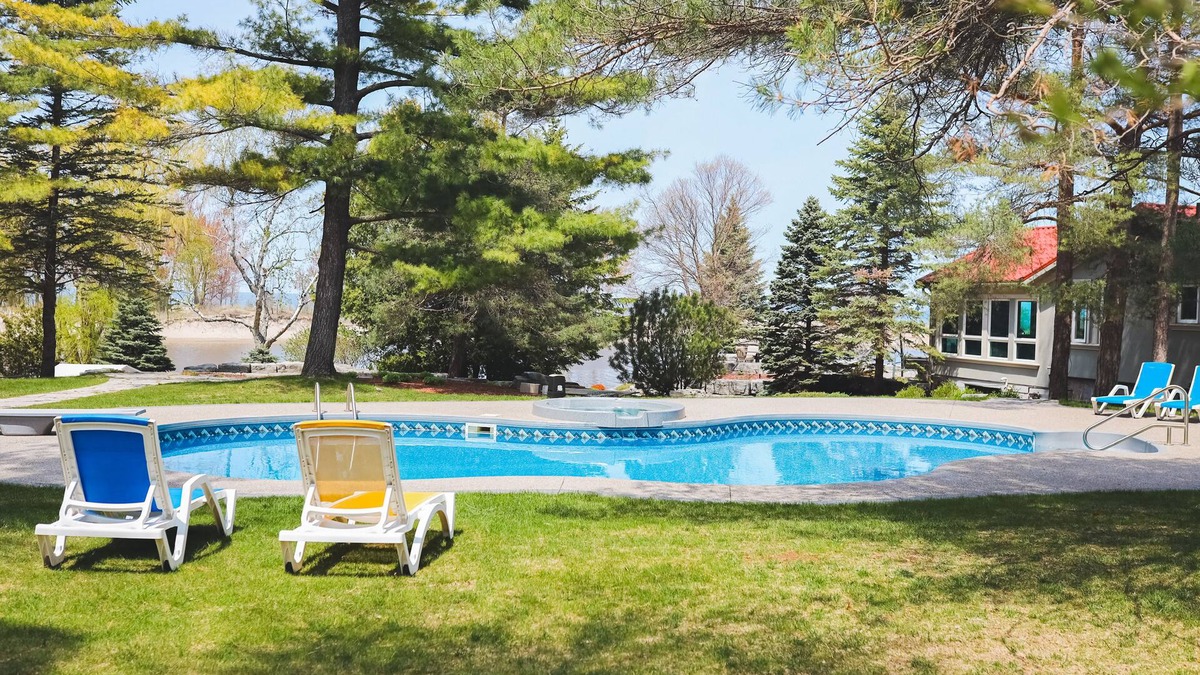 Wasaga Beach Apartment | River View cozy studio cottage with loft, steps shared pool, beach, & firepit