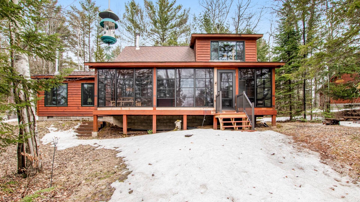 Lac du Flambeau Cabin | Riverfront vacation home with a dock, wood stove, full kitchen, & firepit
