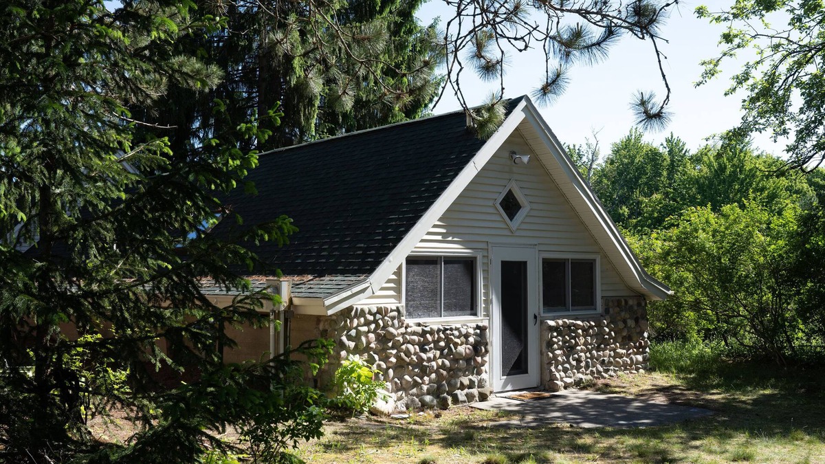 Burt Lake Cottage | Secluded hideaway in the woods! Renovated, well appointed 1928 cottage