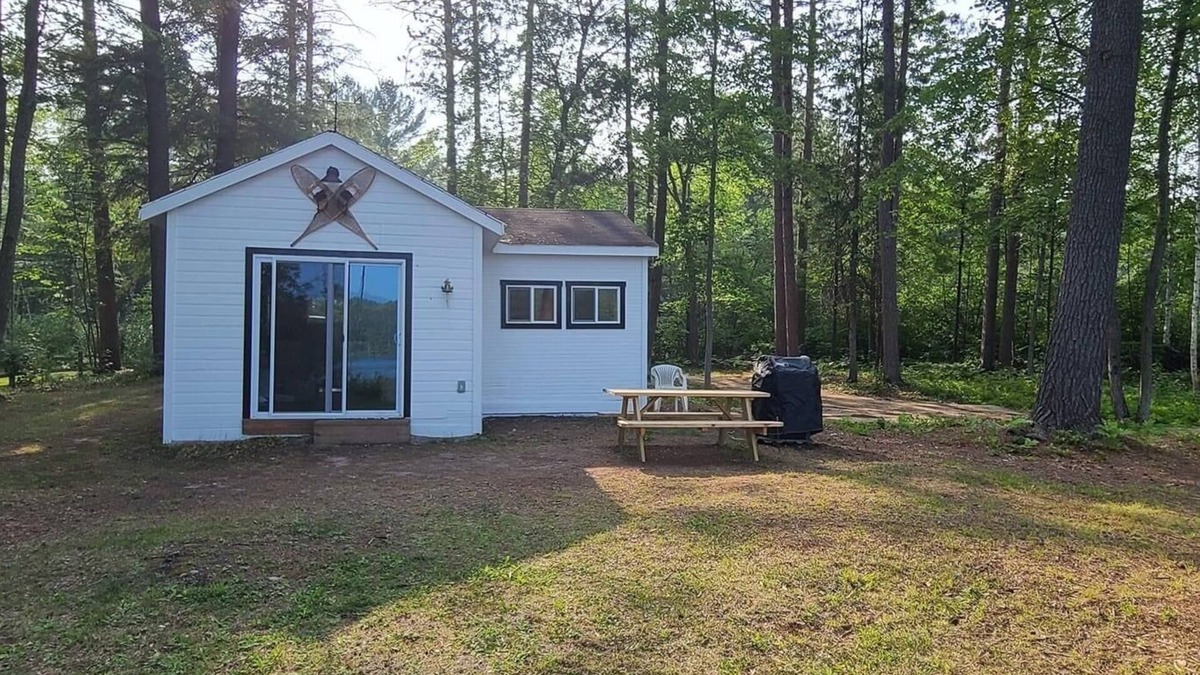 Frederic Cottage | Serene cottage on private lake! Enjoy a private dock, fire pit, canoe, & more!