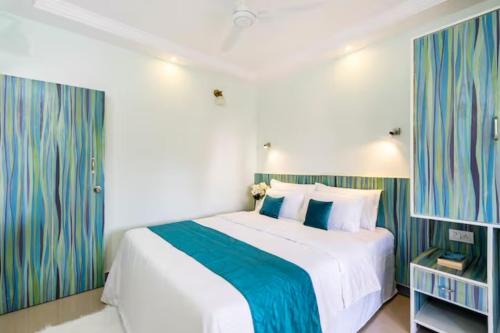 Colva Apartment | Serene Escape One Bedroom Apartment with AC, Wi-Fi, Gym and 5-Minute Walk to the Beach Cativating Tree and Garden Views