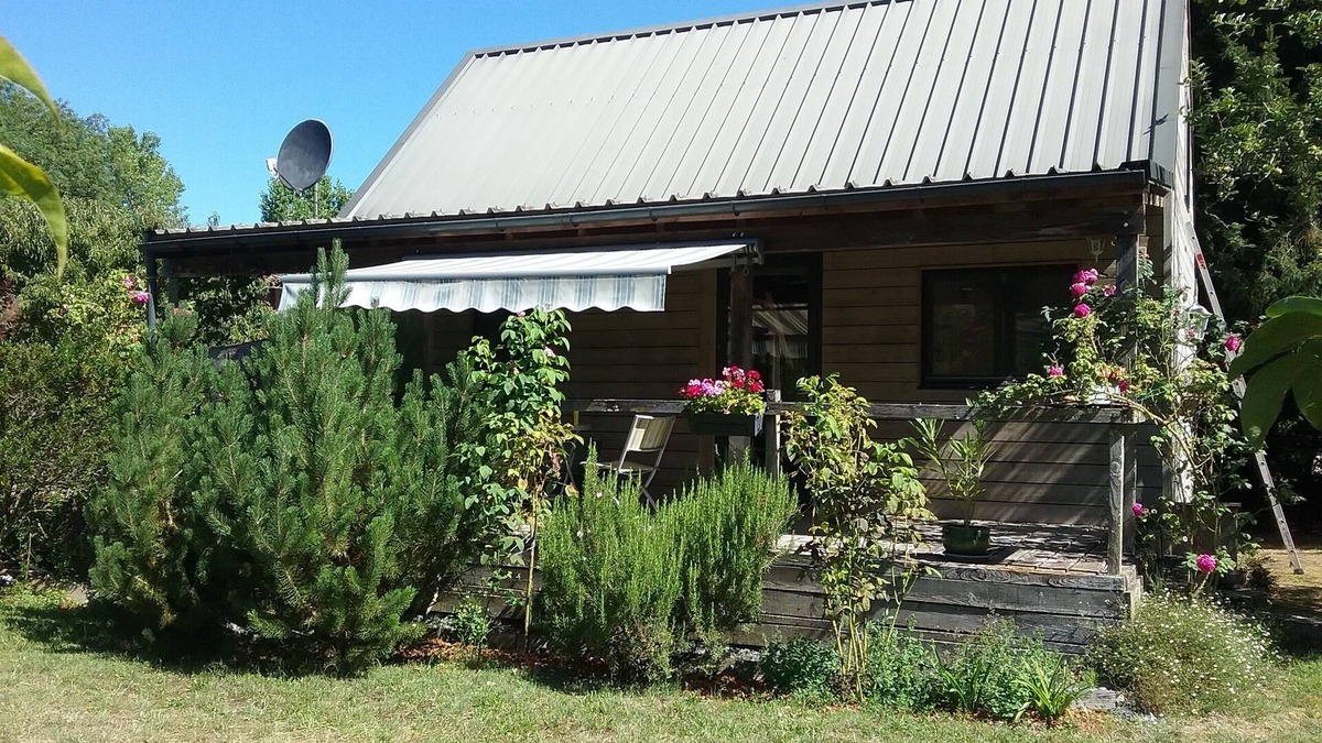 Issigeac House | Small detached wooden house in well-maintained fenced park.