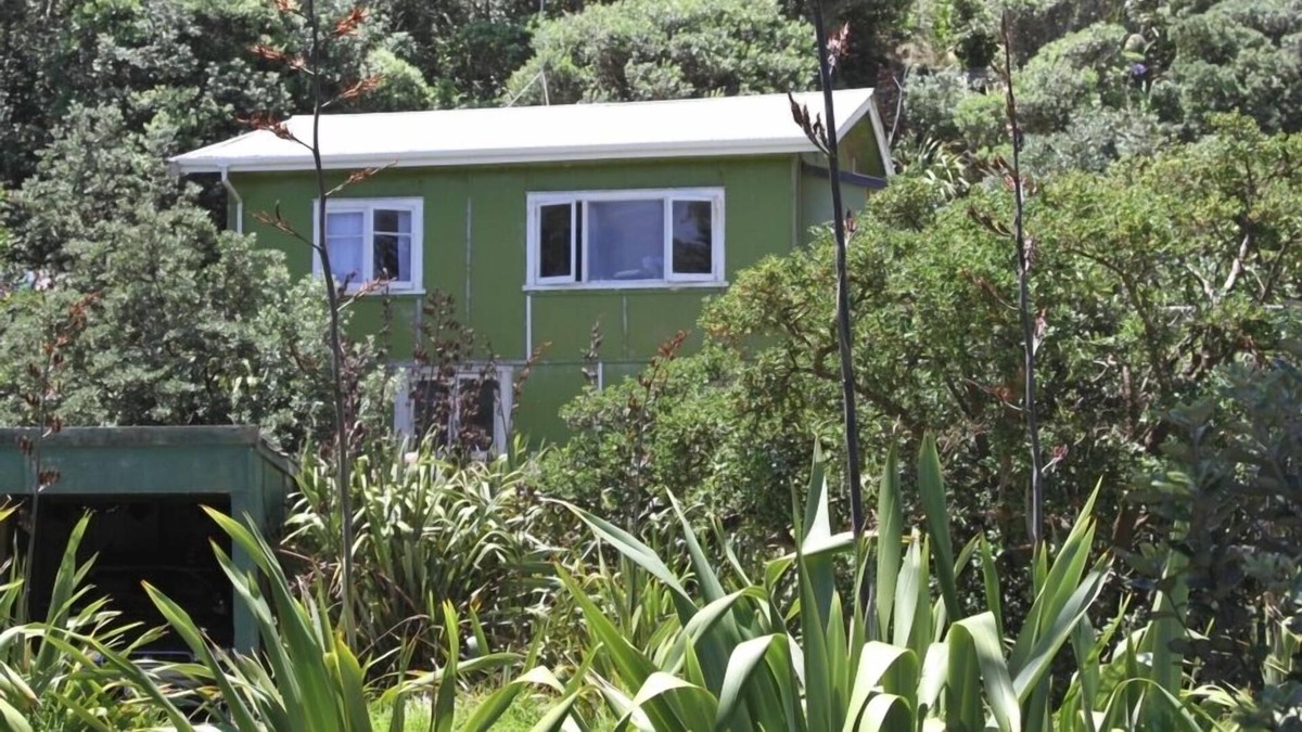 Baylys Beach Cabin | Small Traditional Family Bach within walking distance to beach.