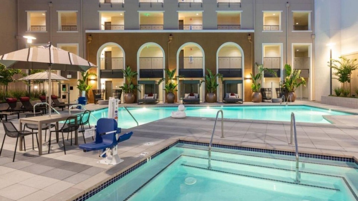 Whisman Station Condo | Spacious 1BR Condo with Serene Pool and Lush Gardens